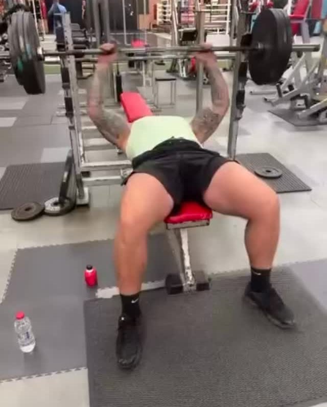 A member bench pressing on the weights floor